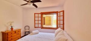 a bedroom with a bed and a window at Casa con Piscina Privada - By Aloha Palma in Calabardina +20 photos