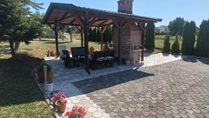 a pavilion with a table and chairs in a yard at Apartman Zdenka 2 in Livno