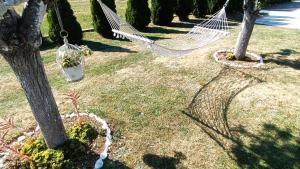a hammock hanging from two trees in a yard at Apartman Zdenka 2 in Livno