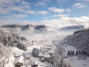 a town covered in snow with mountains in the background at B&B an ciazza in Calizzano
