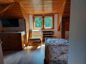a bedroom with a bed and a desk and a window at Baltic in Łeba