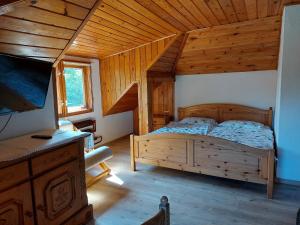 a bedroom with a bed in a wooden cabin at Baltic in Łeba