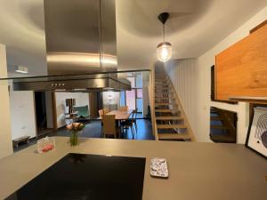 a kitchen and living room with a staircase in a house at Hiša Blašč Wellness in Kobarid