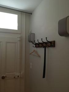 a room with a weapon on the wall and a door at Domitine in Besançon