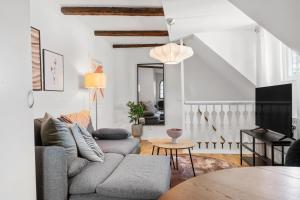 a living room with a couch and a table at Magle Lilla Kyrkogata in Lund