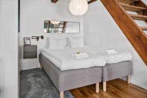 a bedroom with a large bed with white sheets at Magle Lilla Kyrkogata in Lund