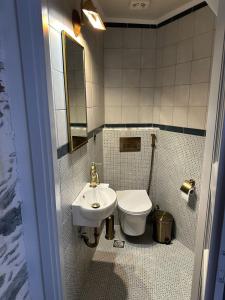 a small bathroom with a sink and a toilet at Plomari Geometer House in Plomari +16 photos