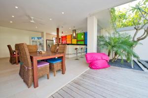 a dining room with a table and some chairs at Villa True Colors in Legian