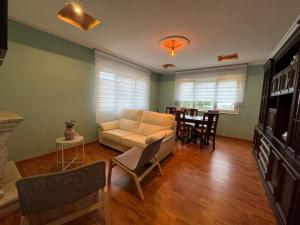 a living room with a couch and a table at Chalet Abelleira Playa Barreiros in Barreiros