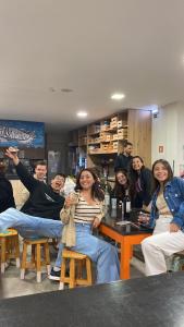 a group of people sitting around a table at WOT Ericeira Surf Hostel in Ericeira