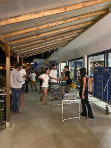 a group of people standing around a table at WOT Ericeira Surf Hostel in Ericeira