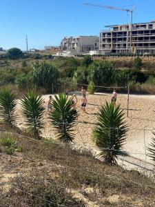 a group of people playing soccer on a beach at WOT Ericeira Surf Hostel in Ericeira