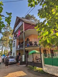 a building with people standing outside of it at Hostel Ureki Kidobani in Ureki
