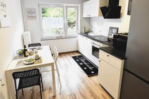 a small kitchen with a table and a counter top at VAZ Apartments Work & Relax in Remscheid