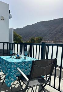 una mesa con un mantel azul en el balcón en NORAY Playa de Mogán, en Puerto de Mogán