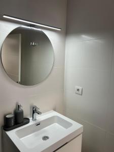 Un baño blanco con lavabo y espejo. en NORAY Playa de Mogán, en Puerto de Mogán 15 fotos más