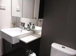 a bathroom with two sinks and a toilet at Docklands Serenity in Melbourne +14 photos