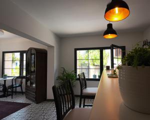 a living room with a table and chairs and windows at Dia Urla in Urla