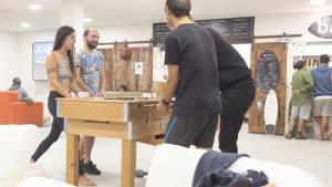 a group of people standing around a table at WOT Ericeira Surf Hostel in Ericeira