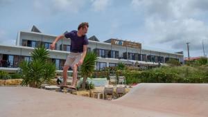 a man riding a skateboard on a ramp at a skate park at WOT Ericeira Surf Hostel in Ericeira