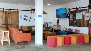 a living room with colorful chairs and a couch at WOT Ericeira Surf Hostel in Ericeira
