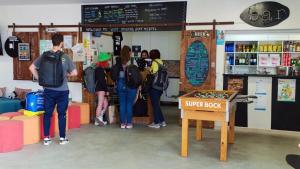 a group of people are standing in a shop at WOT Ericeira Surf Hostel in Ericeira