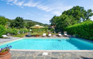 una piscina con sillas y sombrilla en Awesome Home In Castiglion Fiorentino, en Castiglion Fiorentino 18 fotos más