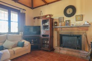 ein Wohnzimmer mit Couch und Kamin in der Unterkunft Casa Rural Los Miradores in Marchena