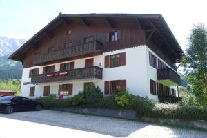a building with a car parked in front of it at Fewo Hinterthal am Hochkönig in Hinterthal +6 photos