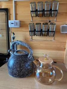 a blue tea kettle and a glass jar on a counter at Beach HOUSE in Cholpon-Ata