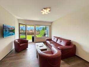 a living room with a couch and two chairs at Valdor Residence- Crans Montana- Swiss Alps in Crans-Montana
