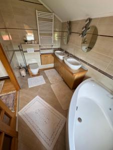 a bathroom with two sinks and a tub and a toilet at Sarajevo Villa Ruza Vjetrova in Vinogradi +29 photos