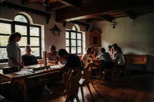 a group of people sitting at tables in a room at Casa de vacanta Aida in Zărneşti