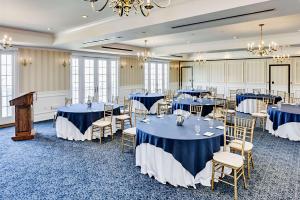 a banquet room with blue tables and chairs at Madison Beach Hotel, Curio Collection by Hilton in Madison