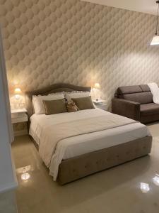 a bedroom with a large bed with a large padded wall at Casa Planzio in Naples