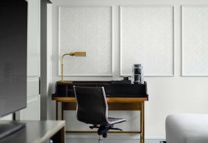 an office with a desk with a chair and a lamp at Hotel Phillips Kansas City, Curio Collection By Hilton in Kansas City