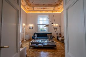 a living room with a couch and a table at Dimora Palanca Boutique & SPA in Florence