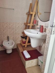 a bathroom with a sink and a toilet at La Tana del Bianconiglio in Ostuni