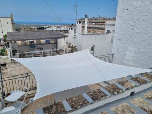 a white tent on top of a building at La Tana del Bianconiglio in Ostuni
