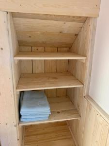 a wooden closet with some folded towels in it at Budget izba pre veľkú rodinu alebo skupinu priateľov in ľubochňa +13 photos