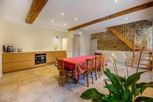 a kitchen and dining room with a red table and chairs at Maison de vacances in Gilly-lès-Cîteaux