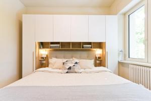 a bedroom with a large bed with a large window at Casa Soleil in Francavilla al Mare