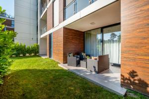 an exterior view of a building with a lawn at Family Fun Siófok Azúr Port With Free Wellness in Siófok