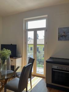 a living room with a glass table and a sliding glass door at Valentine Home Lesa in Lesa