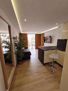 a large living room with a desk and a chair at Deluxe Apart Castle Harbour in Los Cristianos