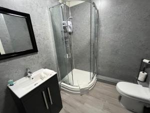 a bathroom with a shower and a sink and a toilet at The New Brighton Hotel in New Brighton