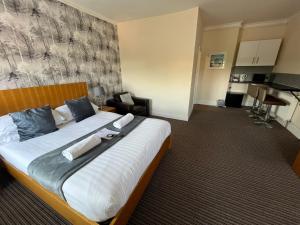 a bedroom with a large bed in a hotel room at The New Brighton Hotel in New Brighton