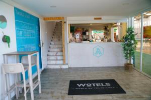 a restaurant with a welcome mat in front of a counter at WOT Peniche Social in Peniche +43 photos