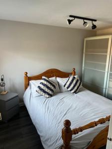 a bedroom with a bed with two pillows on it at Number 70, Portobello, Edinburgh in Edinburgh