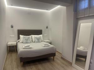 a bedroom with a bed with two towels on it at ENCANTO CUENCA Balcones De La Historia in Cuenca +31 photos